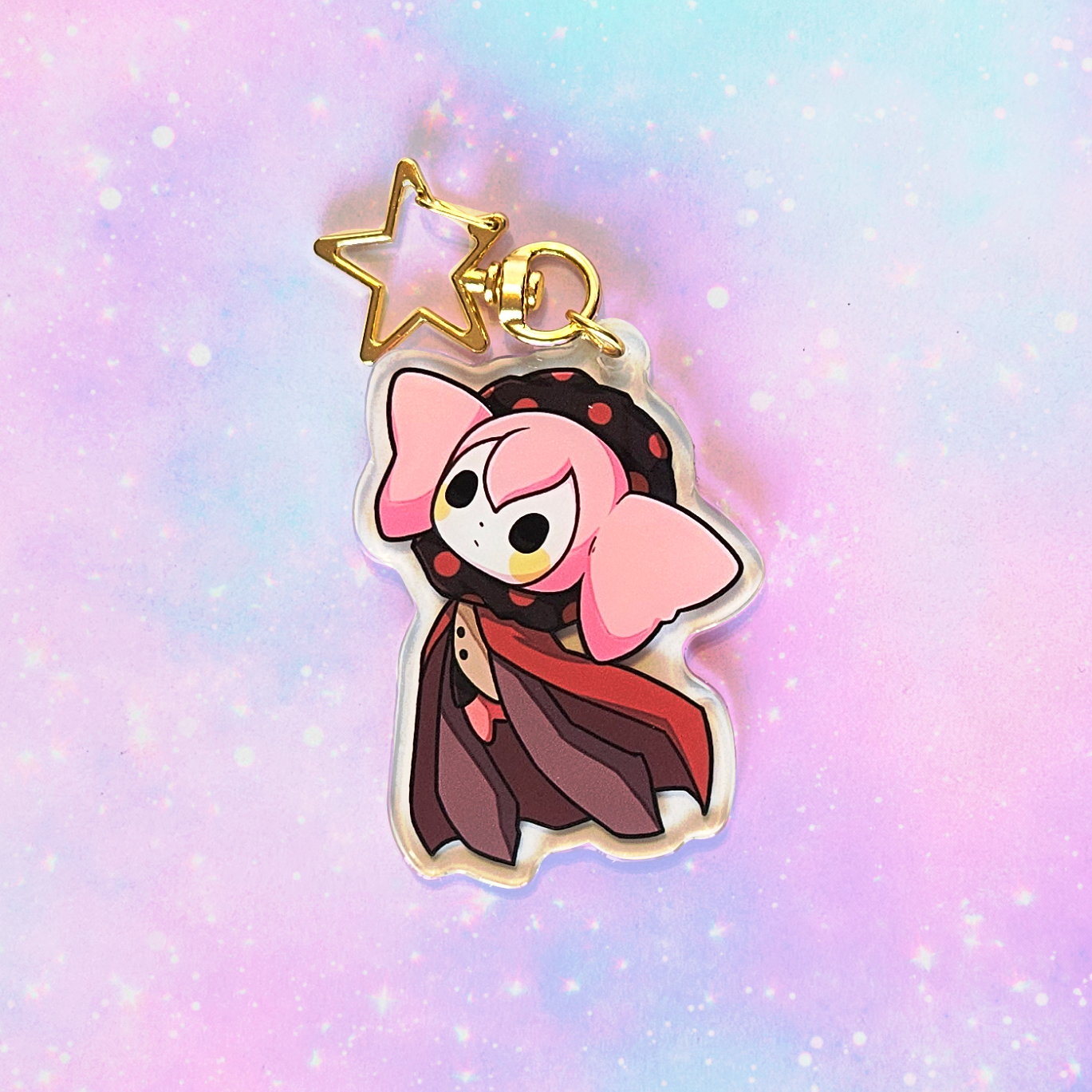 Cartoon character keychain with a star on a pastel gradient background