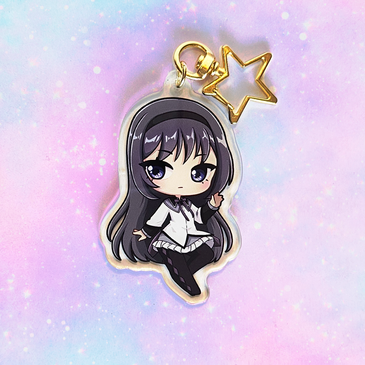 Anime character charm with a gold star on a pastel gradient background