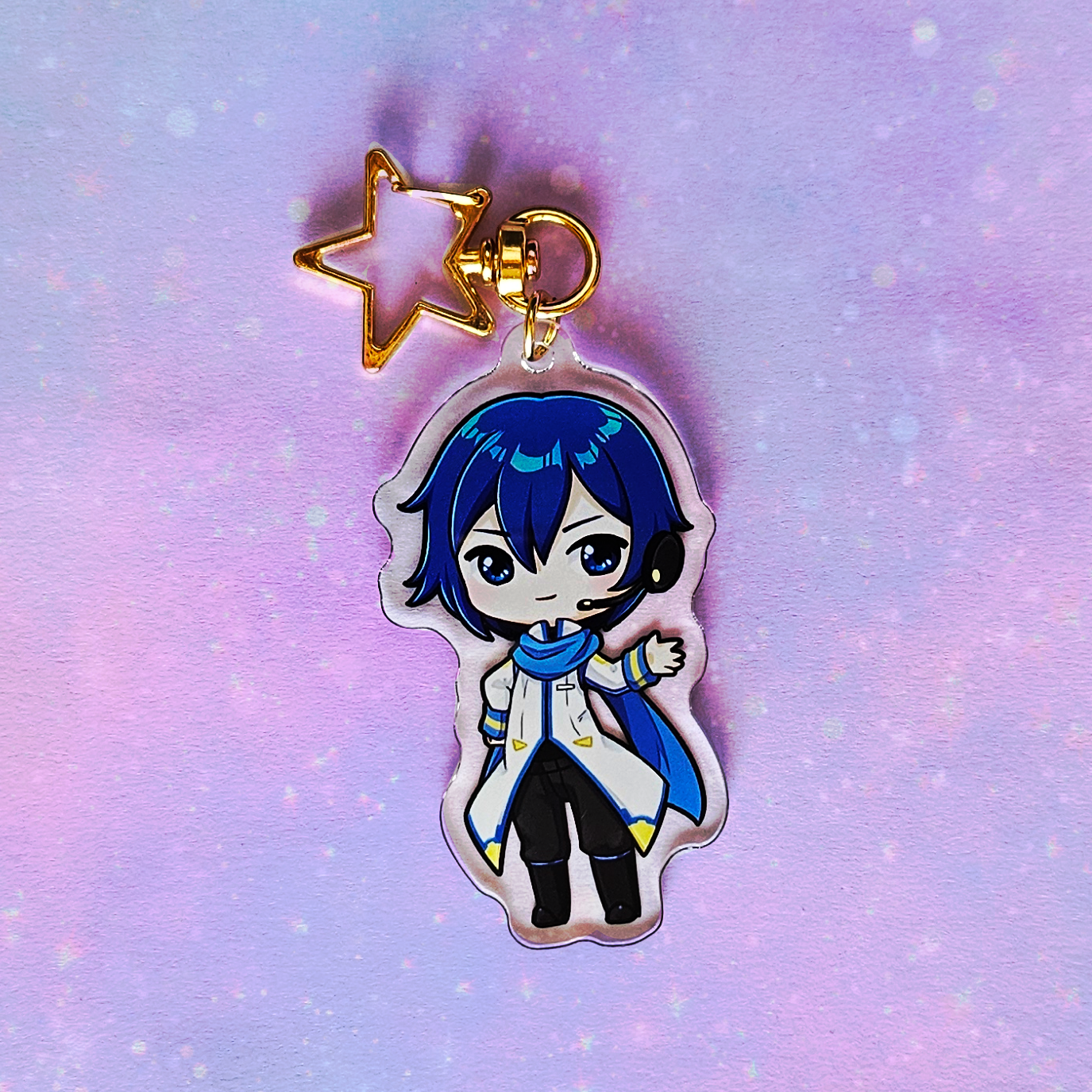 Anime character keychain with a star charm on a gradient purple and blue background