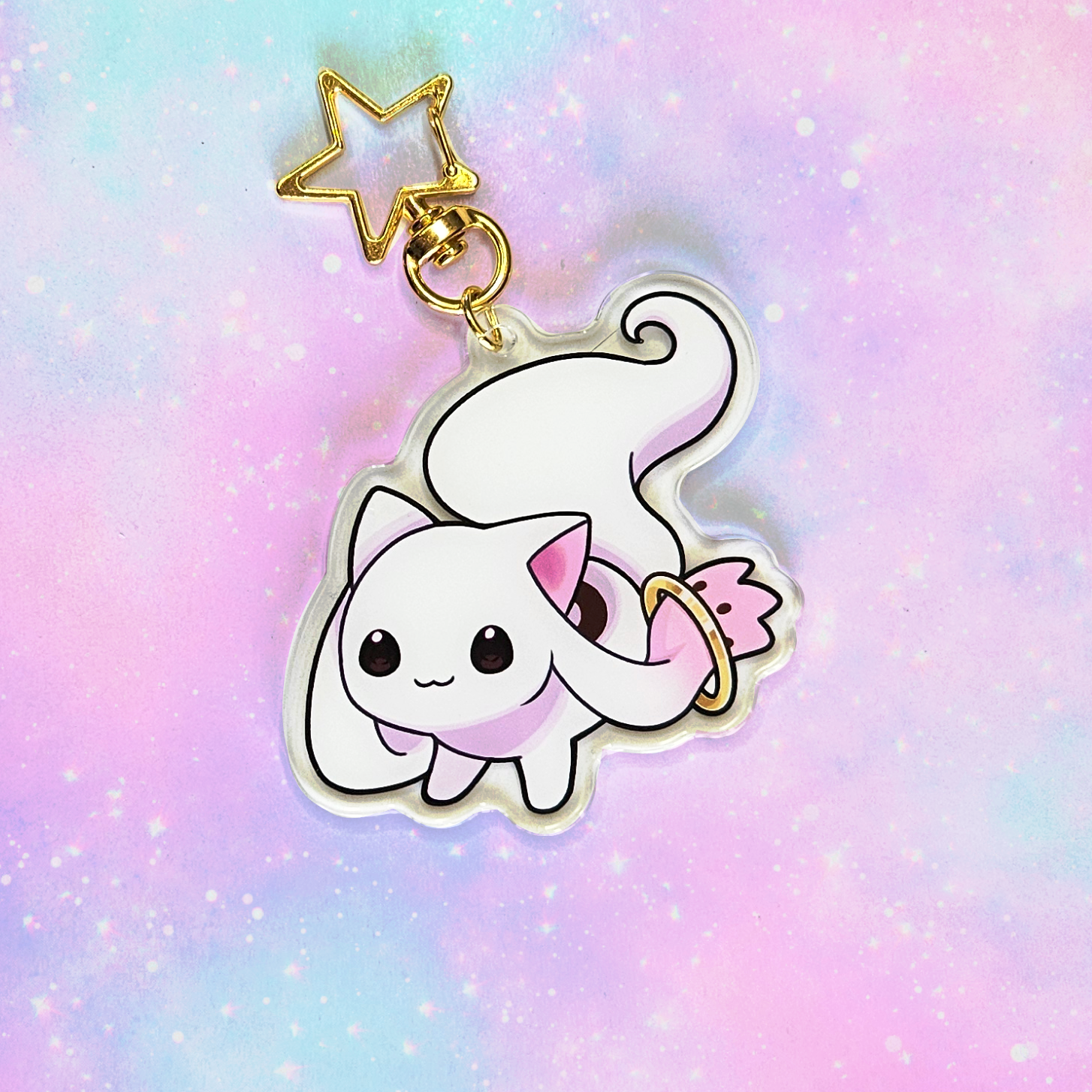 Kawaii cat charm with a star on a pastel gradient background
