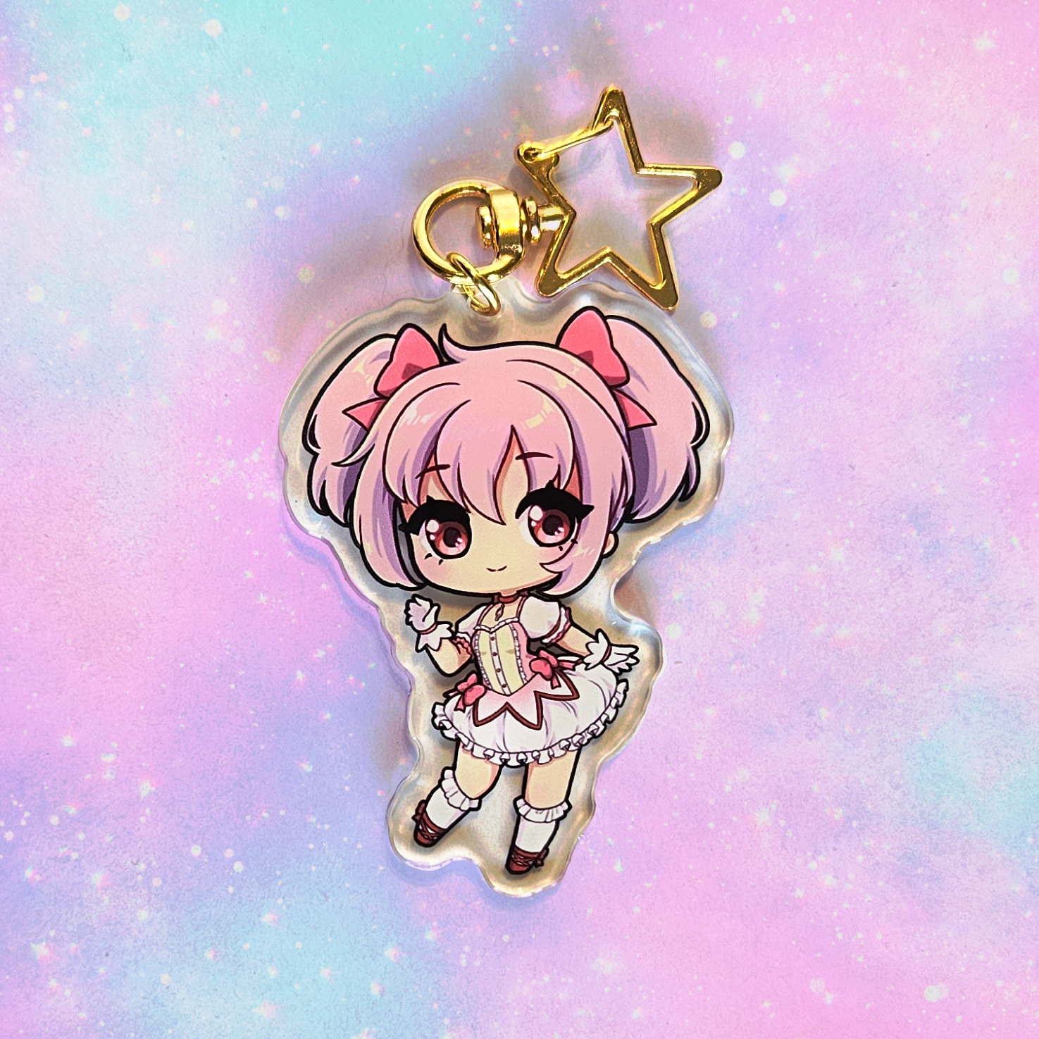 Anime character keychain with pink hair on a pastel gradient background