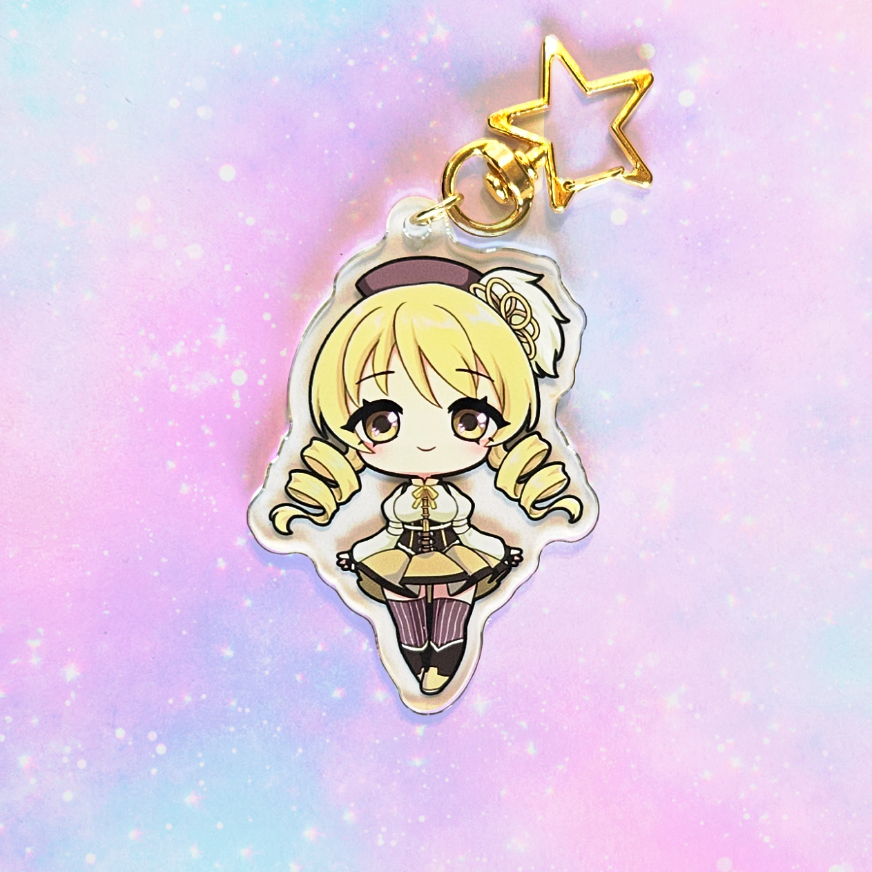 Anime character keychain with a star on a pastel gradient background
