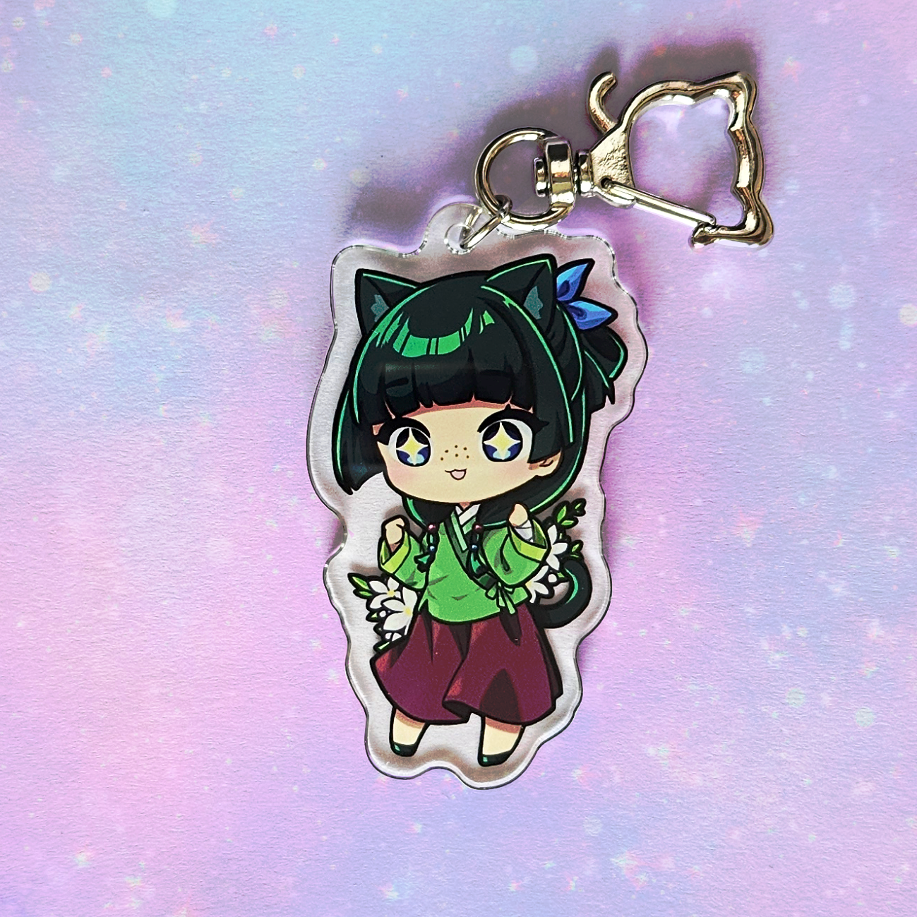 Anime character keychain on a pastel gradient background