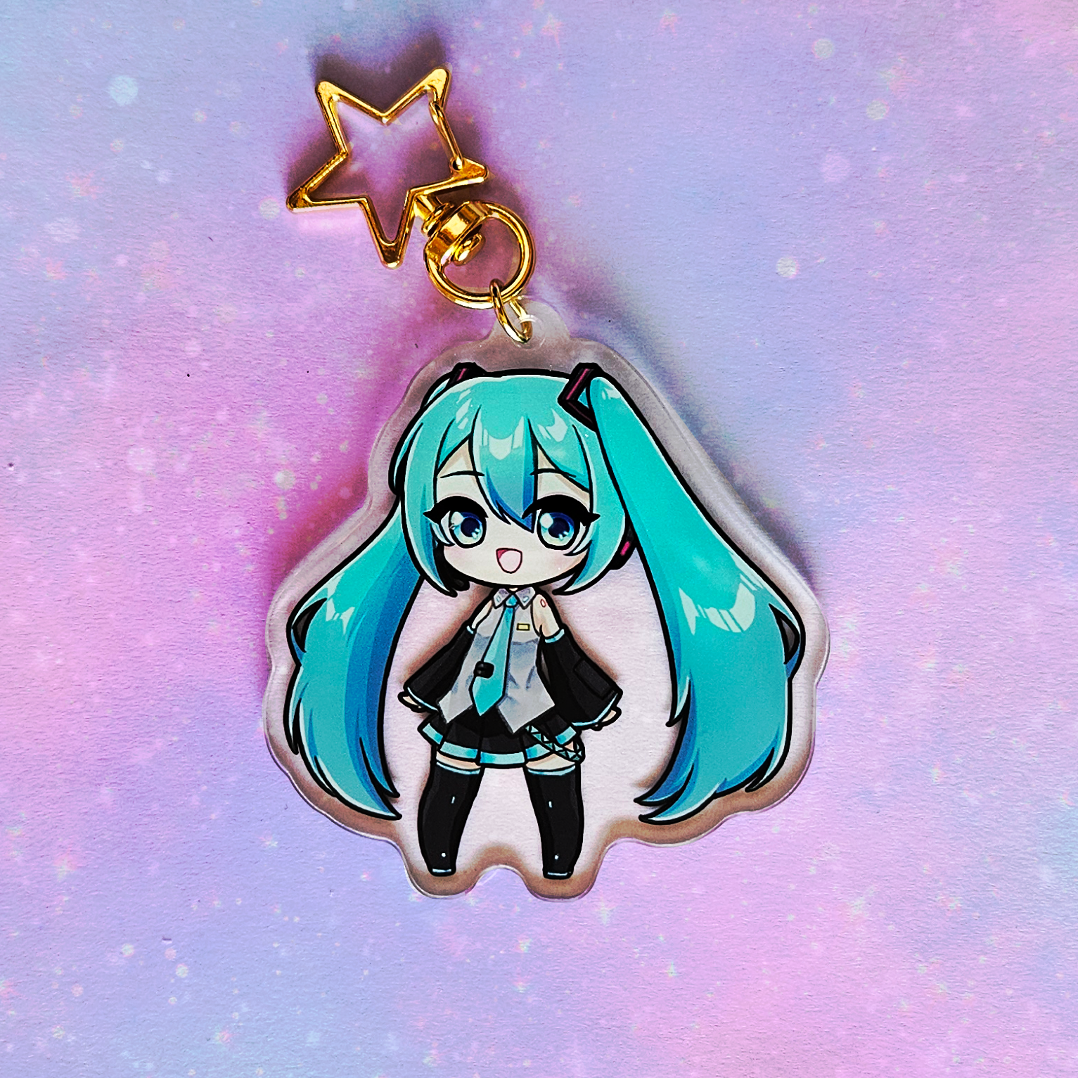 Anime character charm with a star on a gradient purple and pink background
