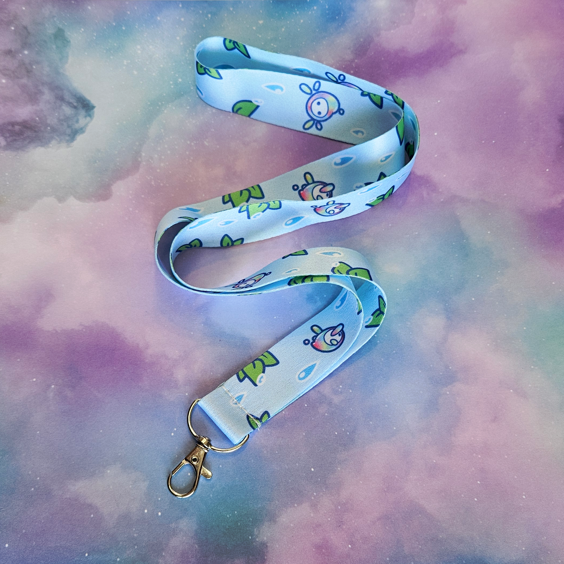 Lanyard with cartoon character design on a colorful, cloud-like background