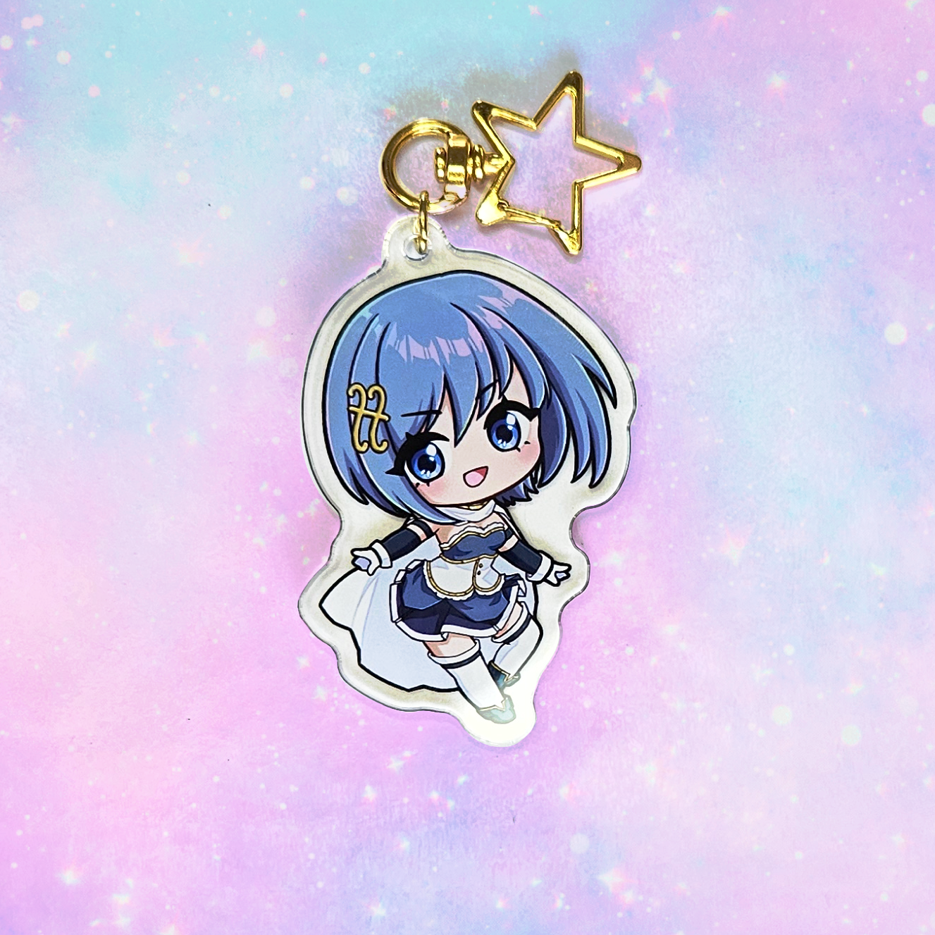 Anime character keychain with blue hair on a pastel gradient background