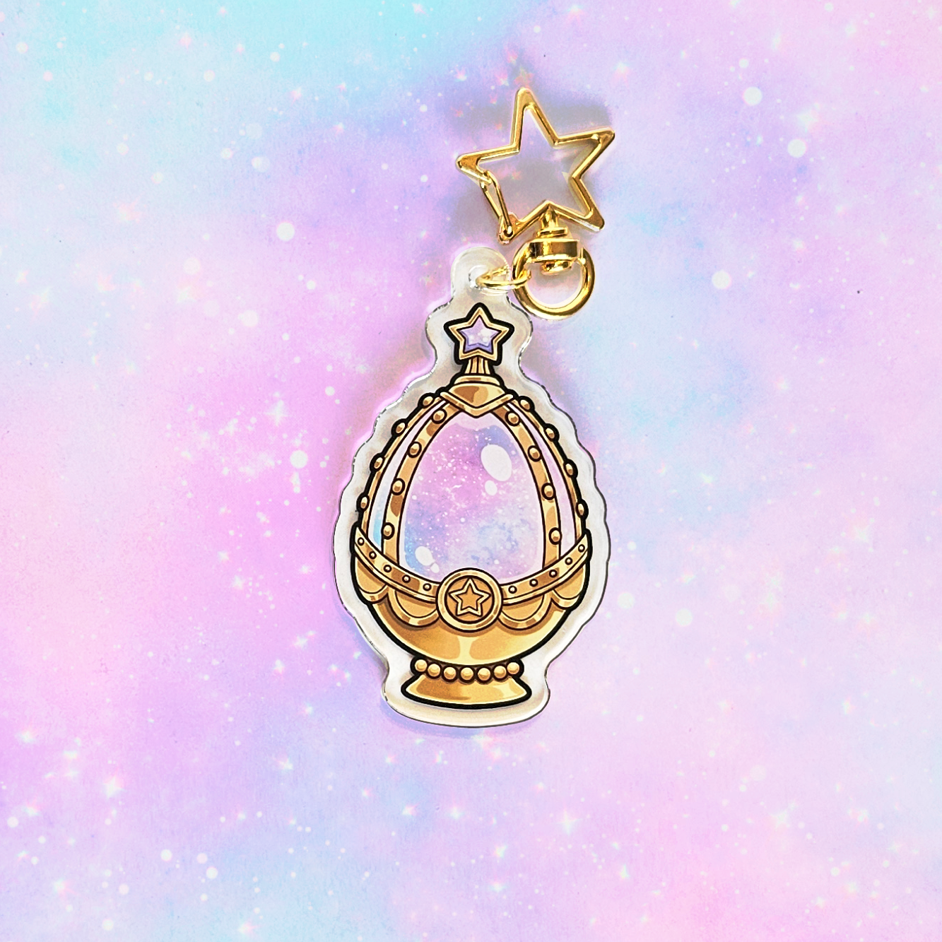 Gold charm with star on a pastel gradient background