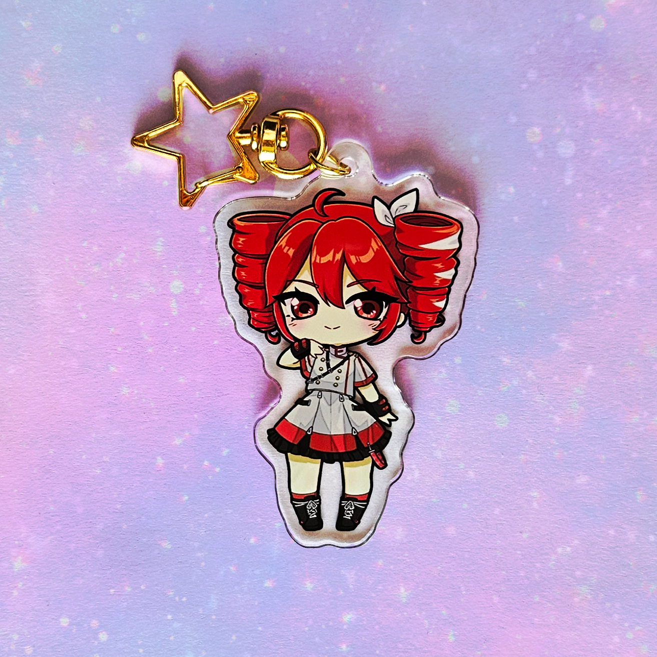 Anime character charm with red hair and a star on a gradient background