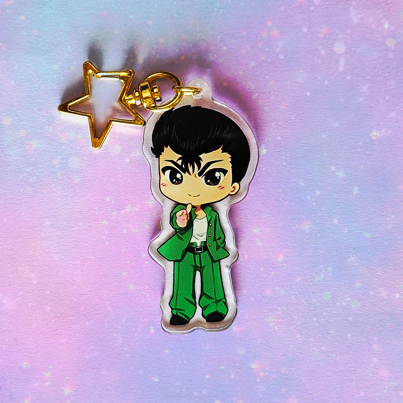 Cartoon character keychain with a gold star on a gradient purple and blue background