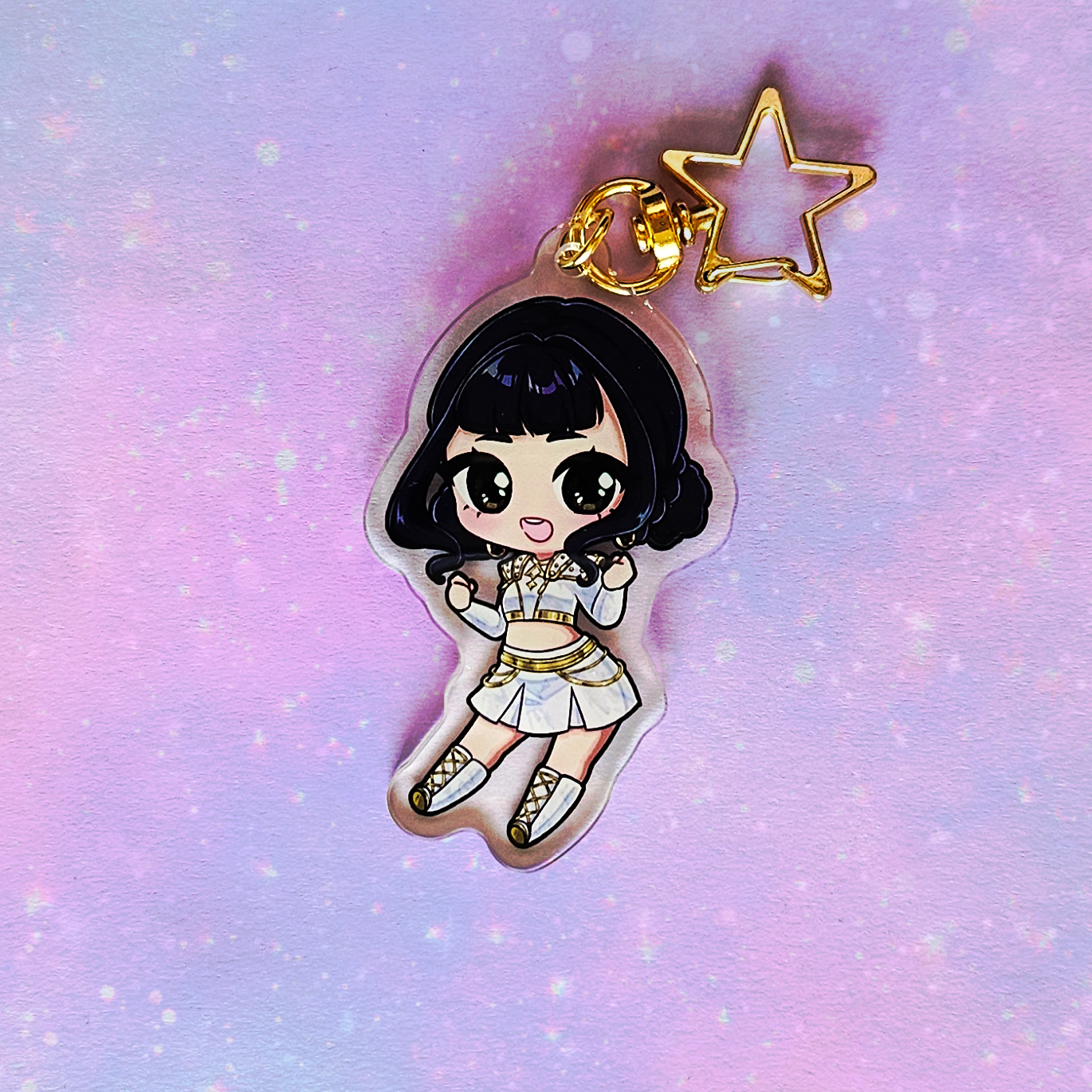 Keychain with a cartoon character on a pastel gradient background